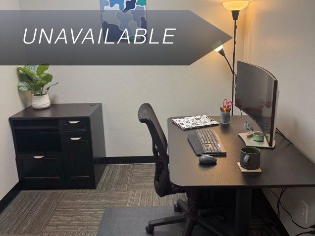 Private mini office Suite 109 with a sit-stand desk, curved monitor, and ergonomic chair for focused work.