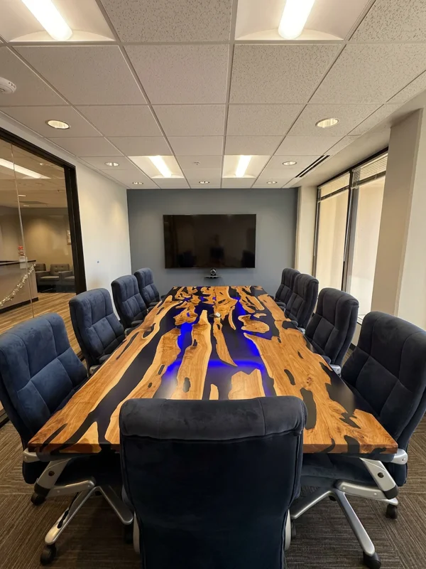 Modern board room at Spoke Coworking with a unique live-edge wood and blue resin river table and executive seating.