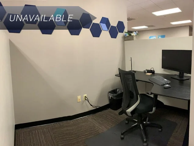 Semi-private dedicated desk 201 with a curved monitor and ergonomic chair in a professional office workspace.
