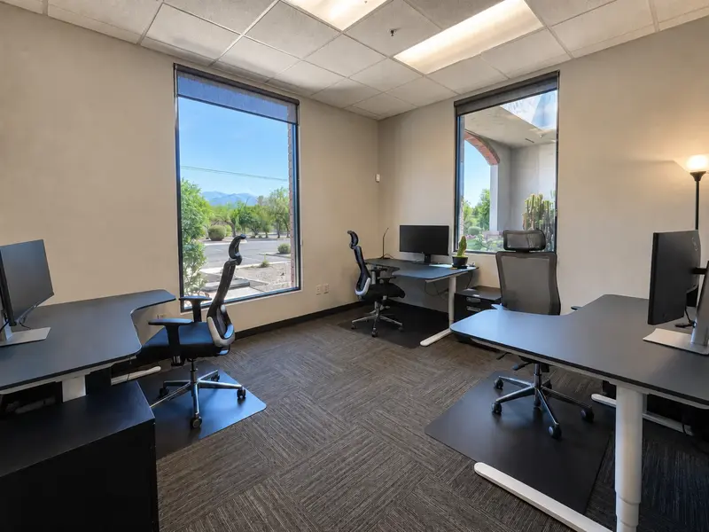 Spacious Suite 127 private team office at Spoke Coworking featuring sit-stand desks and scenic window views.