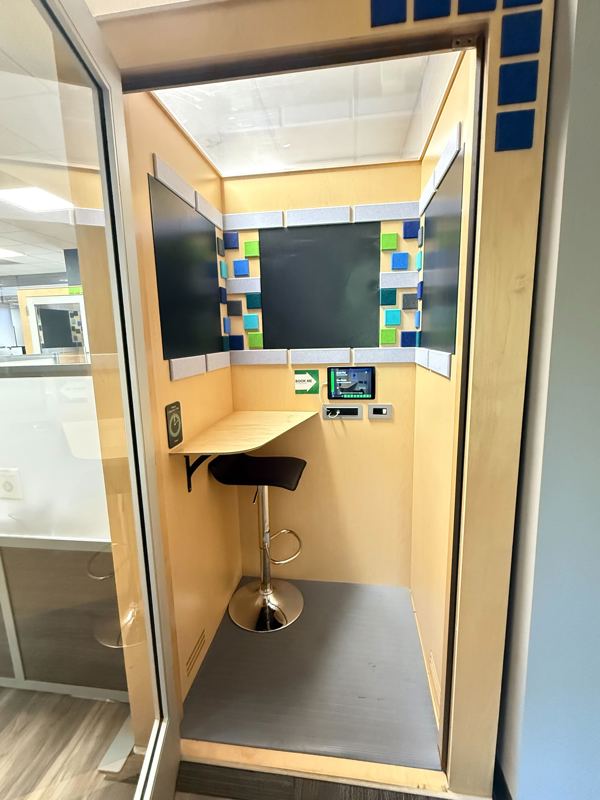 A private soundproof phone booth at Blue Booth with a sit-stand chair and desk for quiet video calls and focused work.