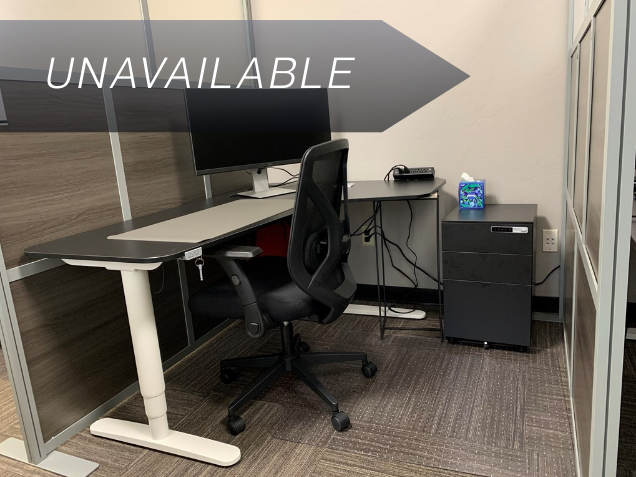 Semi-private Dedicated Desk 209 with an electric sit-stand desk and curved monitor at Spoke Coworking.