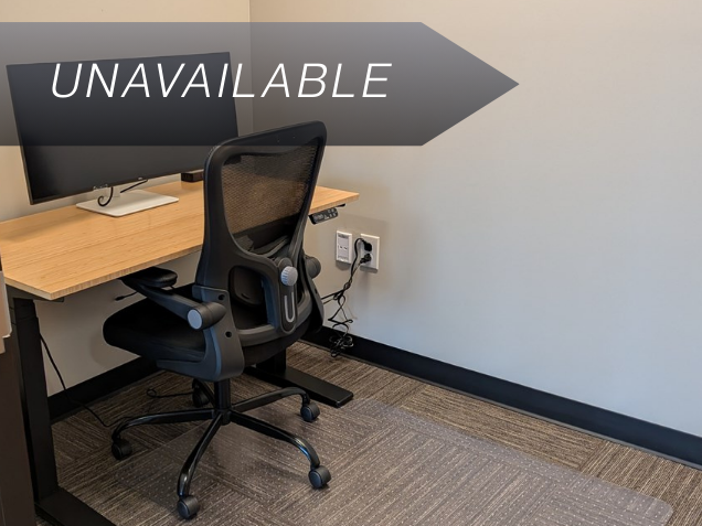 Private micro office Suite 134 with a bamboo sit-stand desk, ergonomic chair, and curved monitor for focused work.