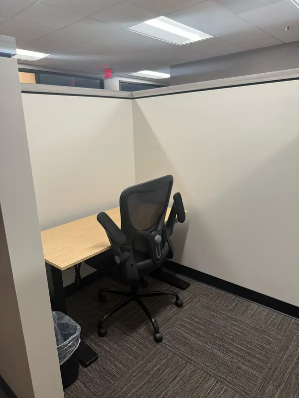 Desk 211, a semi-private dedicated workspace with a bamboo sit-stand desk and ergonomic mesh chair for focused work.