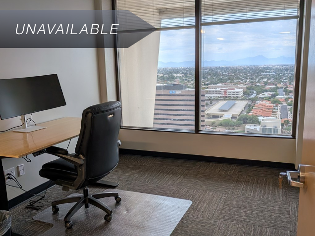 Private executive office Suite 141 with a bamboo sit-stand desk, curved monitor, and panoramic city and mountain views.