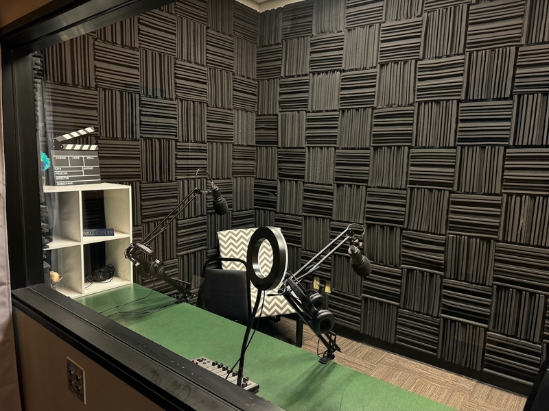 Professional podcast and recording studio at Spoke Coworking Lounge & Suites in Tucson with acoustic foam and microphones.