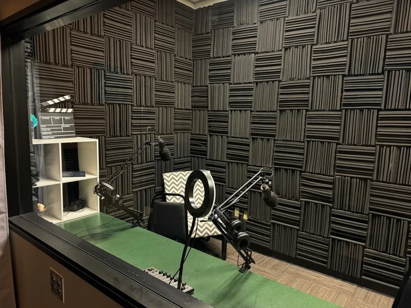 Professional podcast and recording studio at Spoke Coworking Lounge & Suites in Tucson with acoustic foam and microphones.