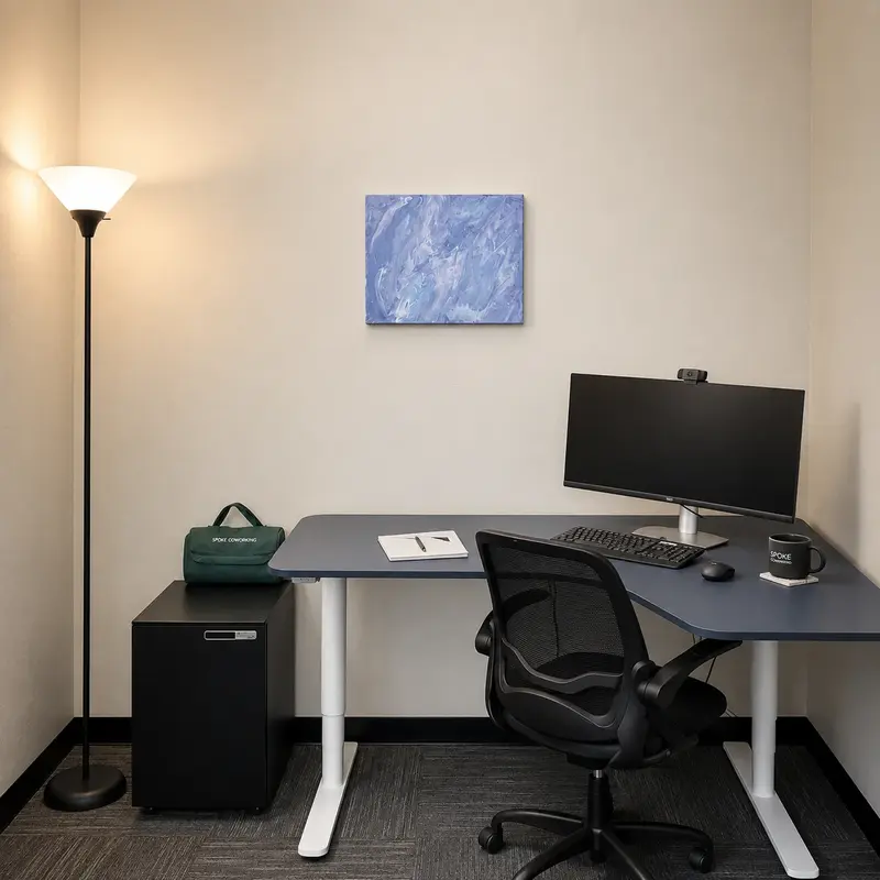 Private office Suite 107 in East Tucson with an electric sit-stand desk, curved monitor, and ergonomic mesh chair.